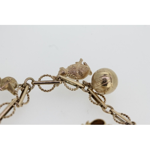 464 - 9ct gold charm bracelet with heart shaped clasp and holding six individually hallmarked 9ct gold cha... 