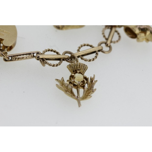 464 - 9ct gold charm bracelet with heart shaped clasp and holding six individually hallmarked 9ct gold cha... 