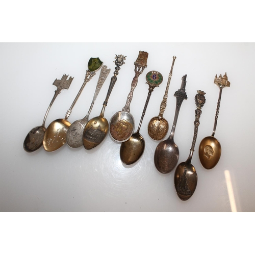 603 - Hallmarked silver souvenir teaspoons, gross 125g.