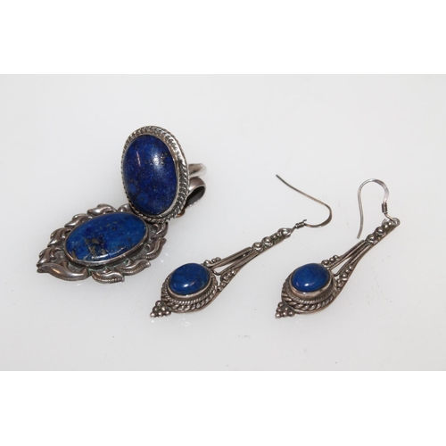 625 - Suite of white metal and lapis lazuli jewellery comprising ring, pendant and pair of earrings.