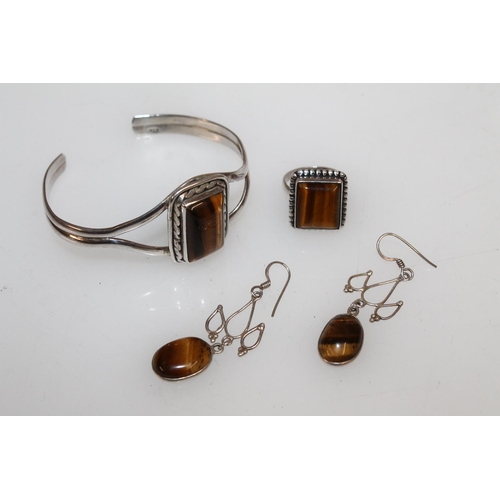 626 - Suite of white metal and tigers eye jewellery comprising bracelet, ring and pair of earrings.