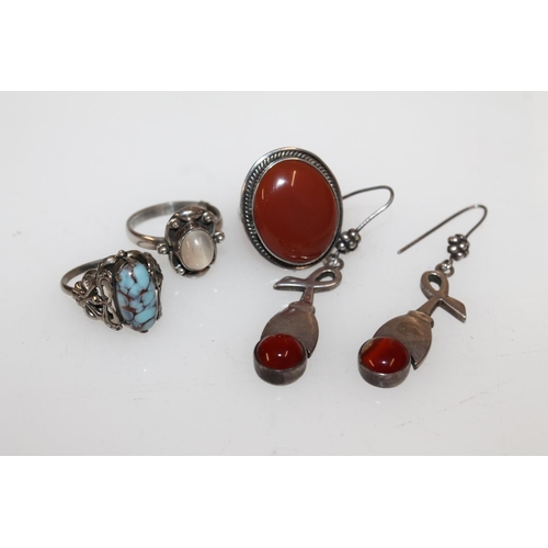 627 - Pair of Scottish style Arts & Crafts earrings set with cabochon stones, a large carnelian caboch... 