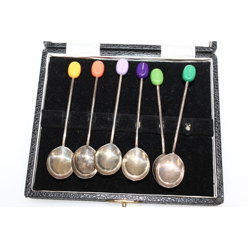 630 - Cased set of six silver coffee spoons with different coloured coffee bean terminals. 