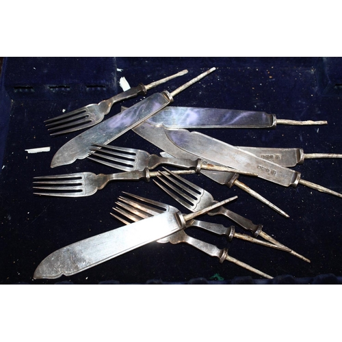 631 - Silver fish knife blades and fork tines with white metal tangs, 240g gross, in rosewood case. 