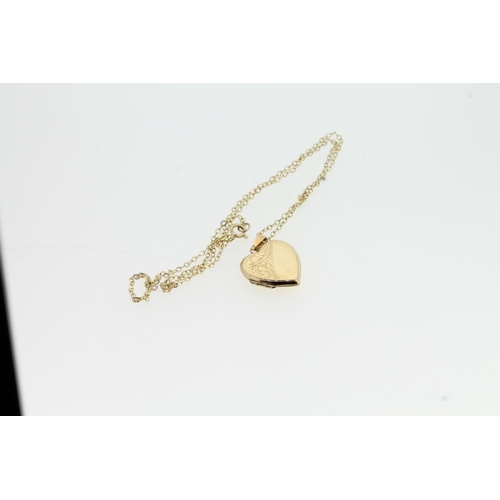 528 - 9ct gold heart shaped locket on unmarked yellow metal chain, locket weight 1.4g.