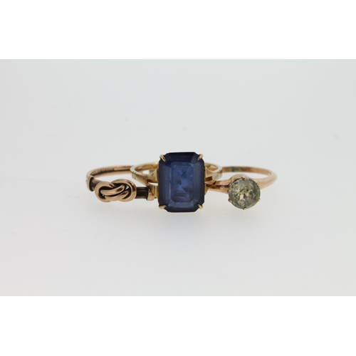 535 - 9ct gold ring set with emerald cut blue stone, a knotwork 9ct gold ring (snipped), and a gilt metal ... 