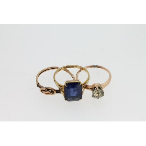 535 - 9ct gold ring set with emerald cut blue stone, a knotwork 9ct gold ring (snipped), and a gilt metal ... 