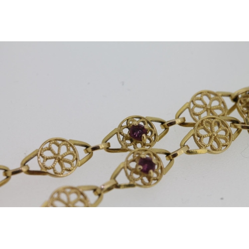 536 - 18ct gold fancy link bracelet set with small amethysts, 5.1g.