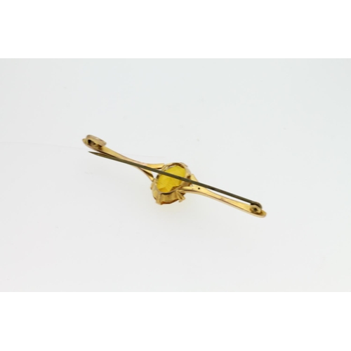 545 - Yellow metal bar brooch set with oval citrine, tests as 9ct, 4.1g.