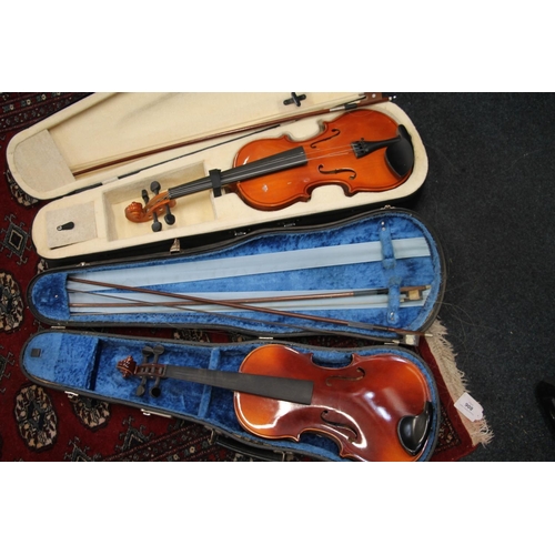 393 - Two cased violins with bows. (2)