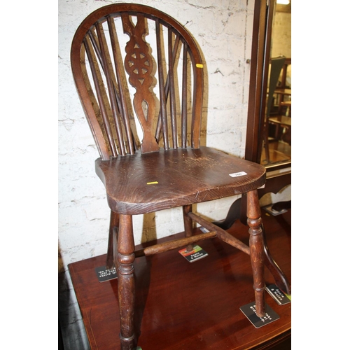 766 - Early 20th century wheel back dining chair.