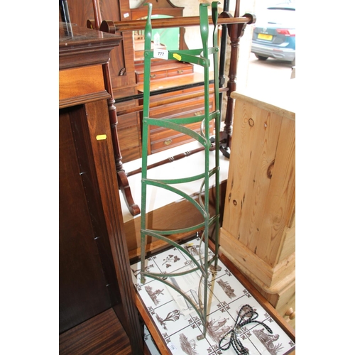 777 - Green painted wrought iron graduated plant stand, 98cm.