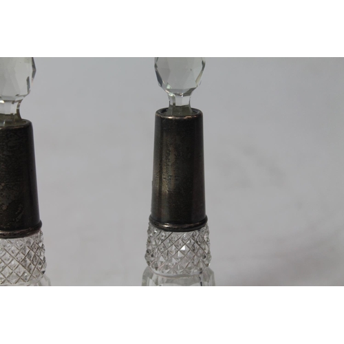 225 - Pair of silver mounted cut-glass scent bottles, 15cm high.