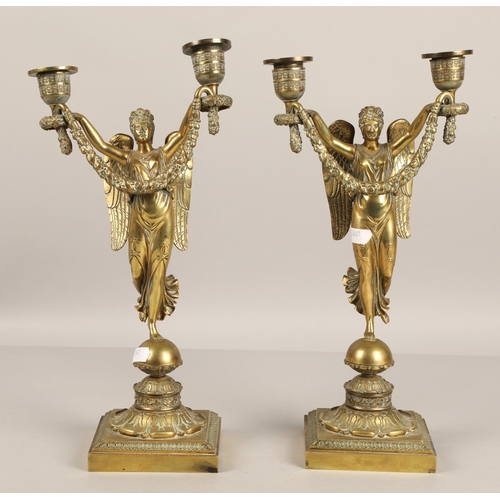 350 - Pair of brass candelabra in the form of winged angels . 30cm