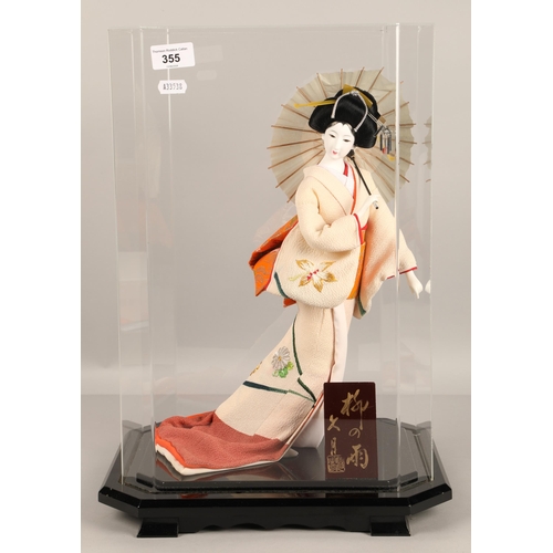 355 - Model of a Geisha girl with parasol in Perspex presentation case.