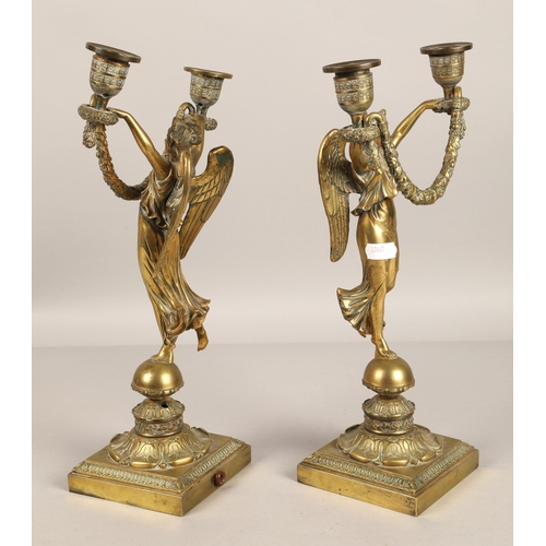 350 - Pair of brass candelabra in the form of winged angels . 30cm