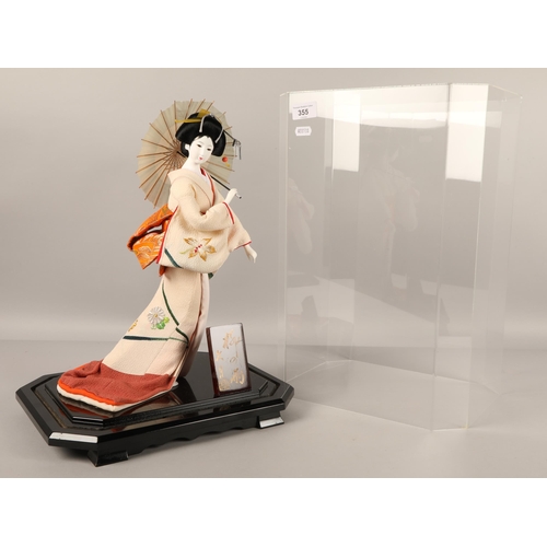 355 - Model of a Geisha girl with parasol in Perspex presentation case.