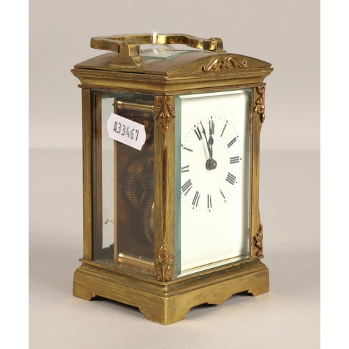 379 - Brass four glass carriage clock with domed top. 12cm excluding handle