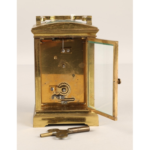 379 - Brass four glass carriage clock with domed top. 12cm excluding handle