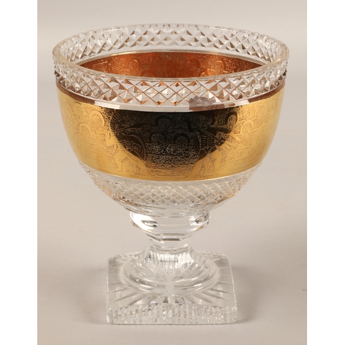 275 - Cut glass crystal pedestal bowl with a gilded gladiator design, 20cm h x 17cm d