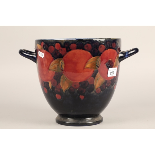 229 - Moorcroft pottery twin handled vase in the pomegranate design , 21cm h