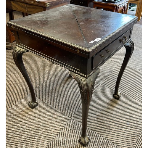 579 - Mahogany envelope games table with fitted drawer, raised on ball and claw feet, 76cm high