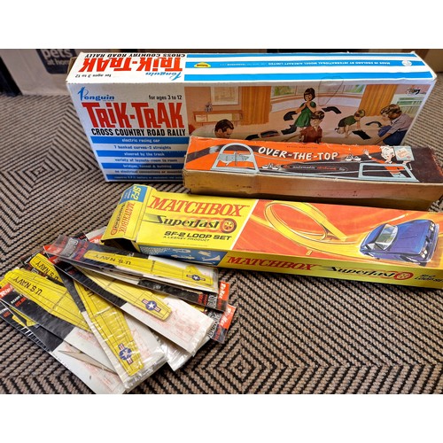 411 - Two boxes of vintage boardgames, Matchbox SF2 loop set, trik trak rally set, monopoly, scrabble, sor... 