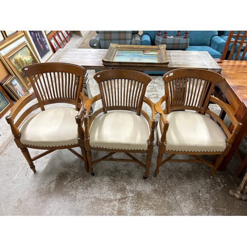 625 - Three cream leather oak open armchairs