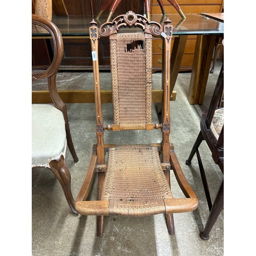 644 - Carved folding cane chair (damaged)