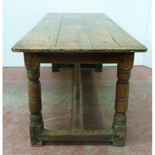 504 - Jacobean Revival jointed oak refectory table with fixed plank top above reeded frieze, on turned col... 