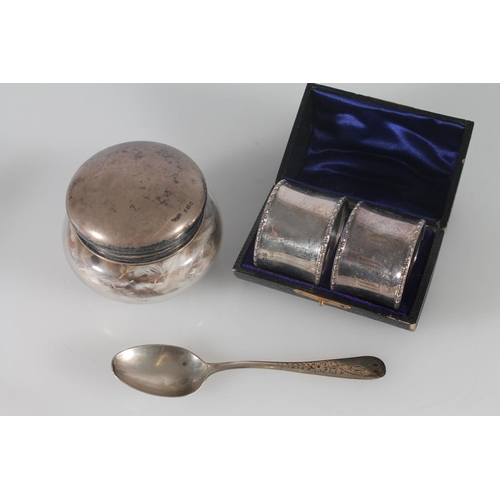 390 - Hallmarked silver napkin rings, silver teaspoon and a silver topped dressing table jar, silver weigh... 