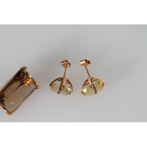 406 - 1970s style large citrine pendant in yellow metal mounts, the suspension ring marked '18KT', also a ... 