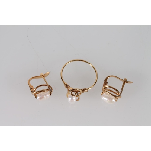 408 - Yellow metal pearl set ring and a pair of matching earrings, marks rubbed, 3.4g.