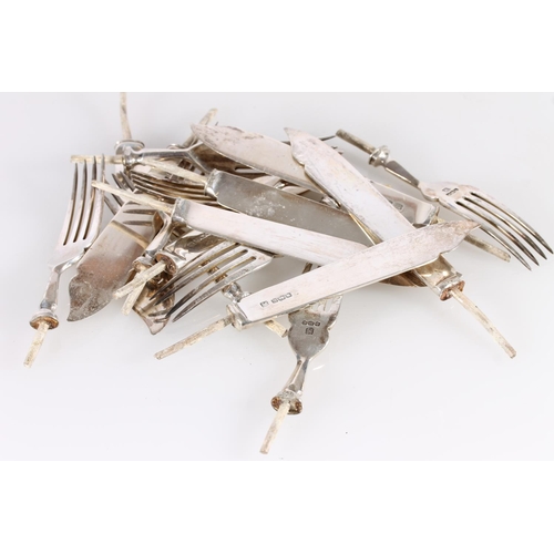 445 - Hallmarked silver knife blades and fork heads with steel cores, gross 514g.