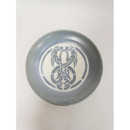 186 - Caerfarchell studio pottery charger, the top decorated with stylised celtic entwined horses on a blu... 