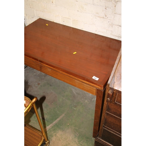 459 - Mahogany fold over games table, bares military crows foot to the stamp dated 1976.