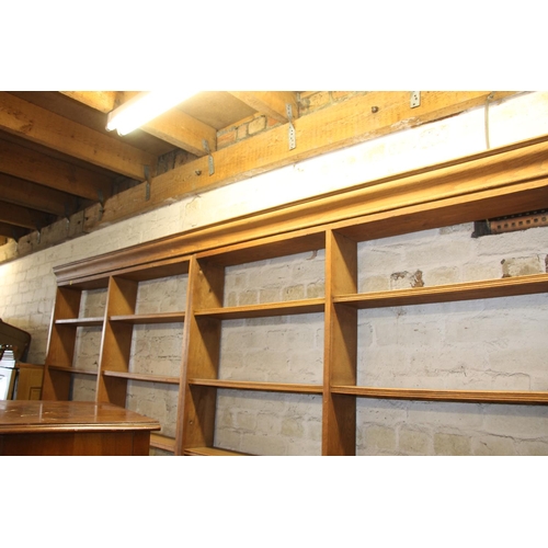 473 - Large four section oak open bookcase on plinth base, 260cm wide.