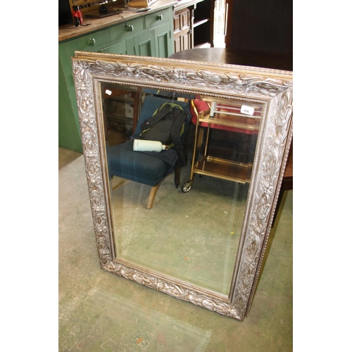 496 - Modern framed wall mirror, frame elaborately decorated in art nouveau style, 107cm tall.