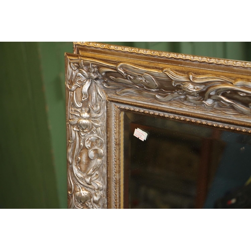 496 - Modern framed wall mirror, frame elaborately decorated in art nouveau style, 107cm tall.