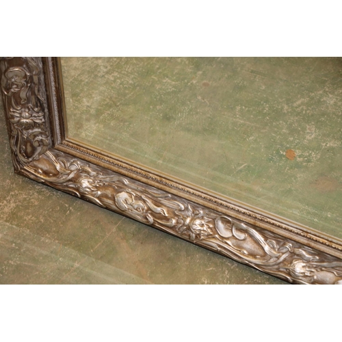 496 - Modern framed wall mirror, frame elaborately decorated in art nouveau style, 107cm tall.