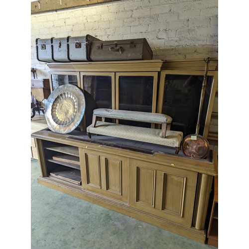 480 - Large scumbled pine cabinet bookcase, the break front top fitted with four glazed doors above cabine... 