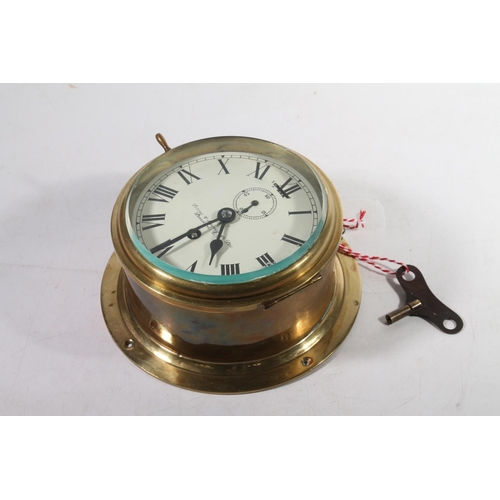 1 - Brass bulkhead clock by Lilley & Reynolds Ltd of London, 21cm diameter.