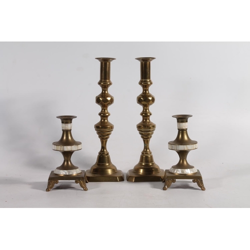 169 - Pair of brass candlesticks and a pair of brass candle holders.