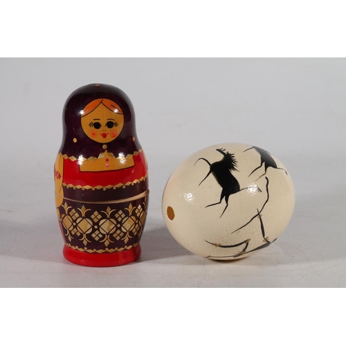 172 - African painted ostrich egg and a Russian doll.