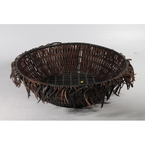 309 - Tribal leather strap basket.