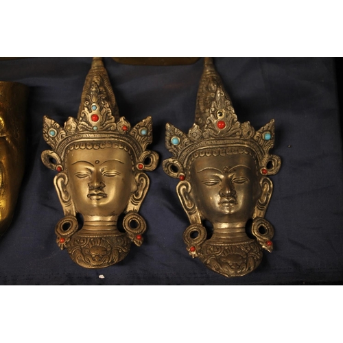 39 - Cast brass Venetian style wall mask, a pair of Thai wall masks and a pair of Diamond Princess candle... 