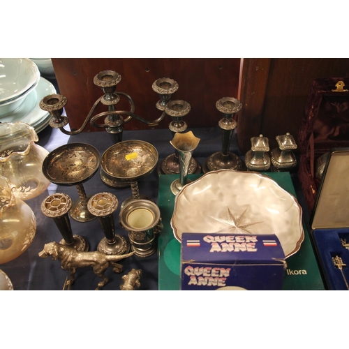 62 - Decorative silver-plate to include candlesticks, figurines, cups, souvenir spoons, etc.