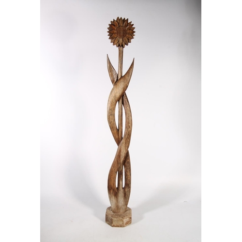 76 - Freeform carved wooden sculpture in the form of a sunflower, 93cm high.