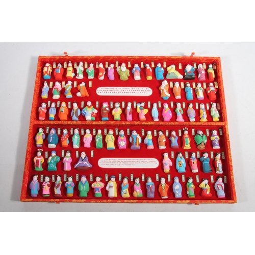 87 - Chinese miniature pottery figurines in original red case after The Red Dream.