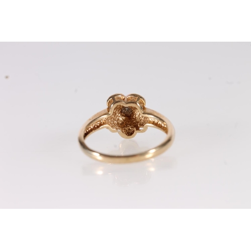 102 - 9ct gold and diamond ring, the small illusion set stone set in flower shaped mount on a plain taperi... 